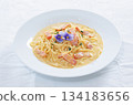 Carbonara cream sauce pasta topped with edible flowers 134183656
