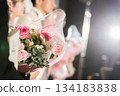 Hand of bride and groom with bouquet 134183838