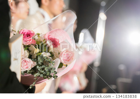 Hand of bride and groom with bouquet 134183838