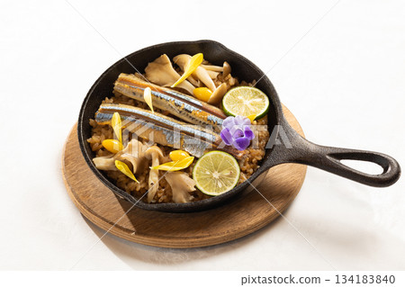 Pacific saury risotto served in a skillet Pacific saury risotto served in a skillet 134183840