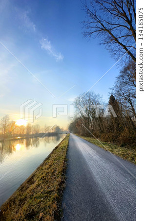 A Serene Sunrise Along the Picturesque Riverside Pathway Awaits Your Exploration Today 134185075