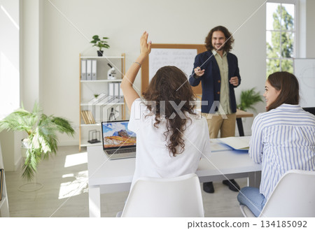 Schoolgirl Raising Hand During Classroom Lesson 134185092