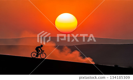 Silhouette cyclist riding bicycle sunset orange sky background sport active lifestyle outdoor cardio workout mountain landscape nature sun light summer motivation healthy extreme race view 134185309