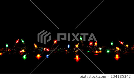 Tangled string of multicolor christmas lights with pink and purple bulbs, festive holiday decoration overlay isolated on black background 134185342