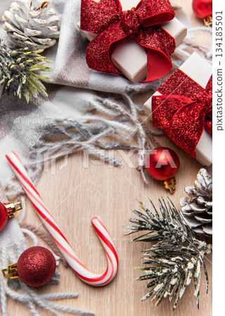 Christmas gifts and candy cane on cozy shawl 134185501
