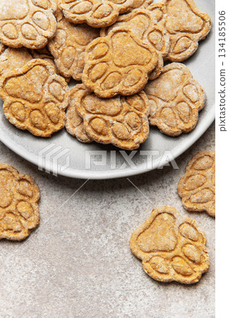 Homemade paw print dog treats on a plate 134185506