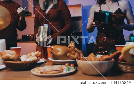 Festive Office Christmas Party with Delicious Food. A beautifully decorated office space with Christmas trees and festive lights, set up for a holiday party. 134185849
