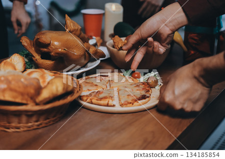 Festive Office Christmas Party with Delicious Food. A beautifully decorated office space with Christmas trees and festive lights, set up for a holiday party. 134185854