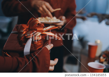 Festive Office Christmas Party with Delicious Food. A beautifully decorated office space with Christmas trees and festive lights, set up for a holiday party. 134185855