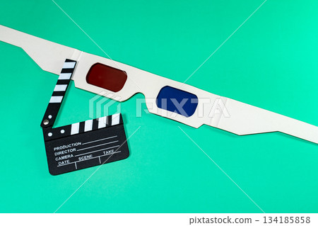 A composition featuring a clapperboard with 3D glasses, all set on a vivid green background, highlighting cinema. A composition featuring a clapperboard with 3D glasses, all set on a vivid green background, highlighting cinema. 134185858