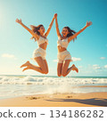 Women jumping on the beach 134186282