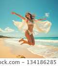 A woman to jump at the beach 134186285