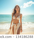 A woman in a swimsuit posing on the beach 134186288