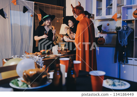 Friends enjoying a Halloween party at a bar making a toast Friends enjoying a Halloween party at a bar making a toast 134186449