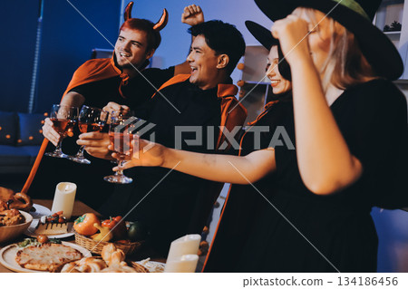 Friends enjoying a Halloween party at a bar making a toast Friends enjoying a Halloween party at a bar making a toast 134186456