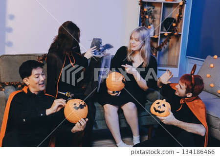 Friends enjoying a Halloween party at a bar making a toast Friends enjoying a Halloween party at a bar making a toast 134186466