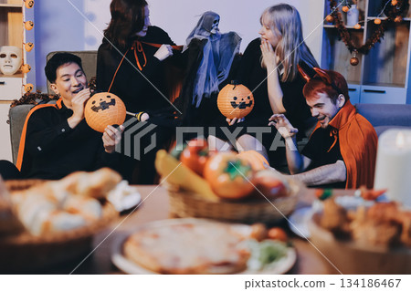 Friends enjoying a Halloween party at a bar making a toast Friends enjoying a Halloween party at a bar making a toast 134186467