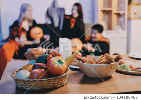 Friends enjoying a Halloween party at a bar making a toast 134186468