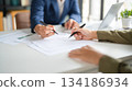 Businessmen working together at desk. 134186934