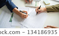 Businessmen working together at desk. 134186935