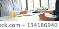 A patient explaining to a doctor. 134186940