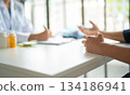 A patient explaining to a doctor. 134186941