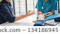 A patient explaining to a doctor. 134186945