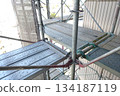 Scaffolding for repair work on the exterior walls of a high-rise apartment building Scaffolding for repair work on the exterior walls of a high-rise apartment building 134187119
