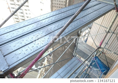 Scaffolding for repair work on the exterior walls of a high-rise apartment building Scaffolding for repair work on the exterior walls of a high-rise apartment building 134187121