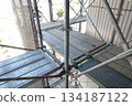 Scaffolding for repair work on the exterior walls of a high-rise apartment building Scaffolding for repair work on the exterior walls of a high-rise apartment building 134187122