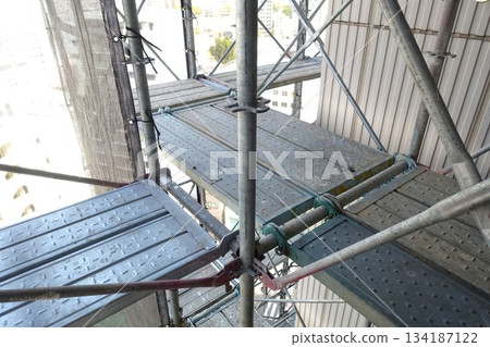 Scaffolding for repair work on the exterior walls of a high-rise apartment building 134187122