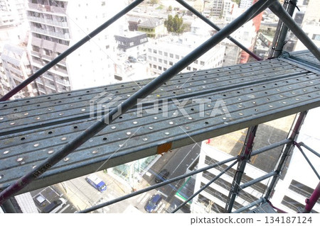 Scaffolding for repair work on the exterior walls of a high-rise apartment building Scaffolding for repair work on the exterior walls of a high-rise apartment building 134187124