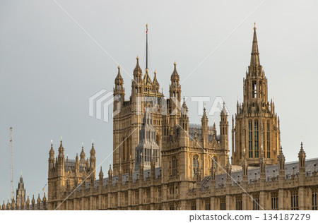 Palace of Westminster (the Houses of Parliament), its distinctive Gothic Revival architecture, characterized by intricate stonework and towering spires. Palace of Westminster (the Houses of Parliament), its distinctive Gothic Revival architecture, characterized by intricate stonework and towering spires. 134187279