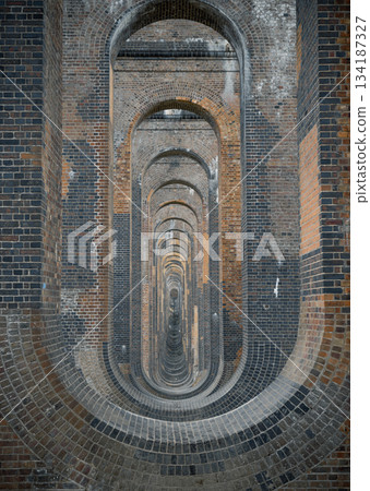 Architectural splendour of Ouse Valley Viaduct or Balcombe Viaduct (Railway viaduct) carries the Brighton Main Line over the River Ouse in Sussex. The semi-circular arches vaulting supporting brick Architectural splendour of Ouse Valley Viaduct or Balcombe Viaduct (Railway viaduct) carries the Brighton Main Line over the River Ouse in Sussex. The semi-circular arches vaulting supporting brick 134187327