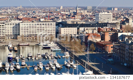 Antwerp city waterfront marina aerial view, boats moored along the docks, historic architecture in background 134187677