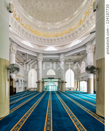 Al-Bukhari Foundation Mosque interior, Kuala Lumpur, Malaysia. Ornate dome, golden calligraphy, and blue prayer carpet. 134187730