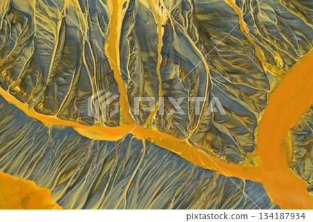 Aerial view of surreal toxic water stream from copper mine in decanting lake. Natural pattern Aerial view of surreal toxic water stream from copper mine in decanting lake. Natural pattern 134187934