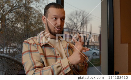 Close-up of a man talking, looking serious and focused during a discussion 134188410