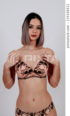 Close-up portrait of a woman in delicate floral lace bra 134188412