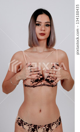 Playful model in leopard-print bra and black lace underwear, hands on hips Playful model in leopard-print bra and black lace underwear, hands on hips 134188435