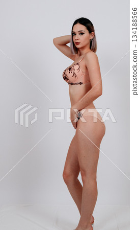 Full-length back view of woman in floral lace lingerie and heels Full-length back view of woman in floral lace lingerie and heels 134188566