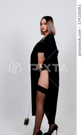 Stylish side profile of a woman in black bodysuit or slimming underwear Stylish side profile of a woman in black bodysuit or slimming underwear 134188861