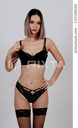 Attractive young model in black lace underwear and sheer stockings Attractive young model in black lace underwear and sheer stockings 134189080