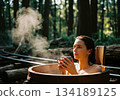 Young woman enjoying a steaming hot tub bath outdoors in a lush green forest retreat setting. 134189125