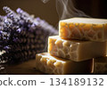 Artisanal honey soap bars stacked with steam and lavender creating a warm spa atmosphere 134189132