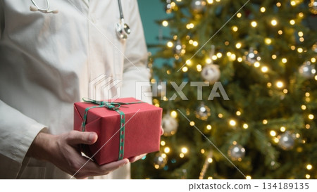 Doctor in White Coat Gives Christmas Gift to Hospital Patients Gift Treatment Doctor in White Coat Gives Christmas Gift to Hospital Patients Gift Treatment 134189135