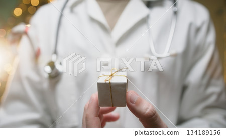 Anonymous Doctor Gives a Small Christmas Gift Box to His Patients Anonymous Doctor Gives a Small Christmas Gift Box to His Patients 134189156