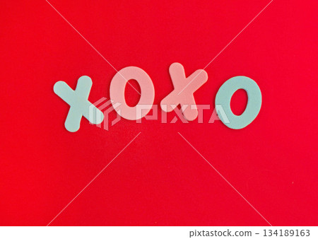 The inscription xo xo from colored letters on a red background. The concept of Valentine's day, love, dating and wedding. Kiss symbol. The inscription xo xo from colored letters on a red background. The concept of Valentine's day, love, dating and wedding. Kiss symbol. 134189163