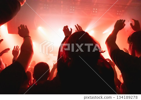 Crowd raising hands at music event Crowd raising hands at music event 134189278
