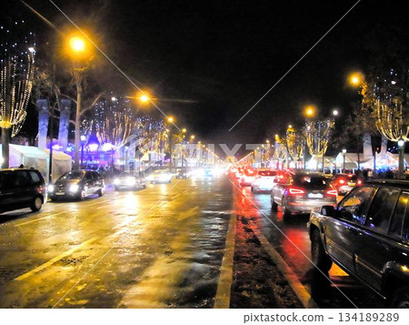 Many cars are driving on the Champs-Élysées in Paris in December Many cars are driving on the Champs-Élysées in Paris in December 134189289